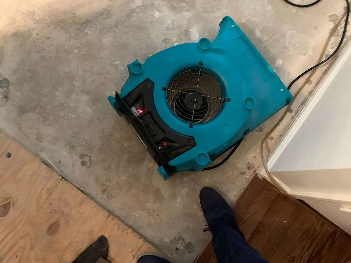 Air mover drying subfloor during Commercial Water Damage Restoration in Homewood